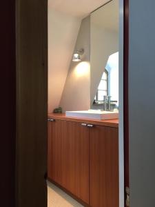 a bathroom with a sink and a mirror at Dichterhaus Dresden in Dresden
