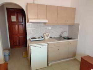 a kitchen with a sink and a counter top at Zefyros Studios in Damnoni