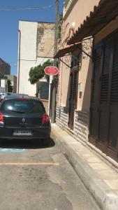 a car parked on a street next to a building at Corteré Guest House in Alliste