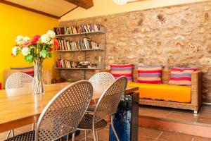 a dining room with a table and chairs and a couch at Massa Vecchia in Massa Marittima