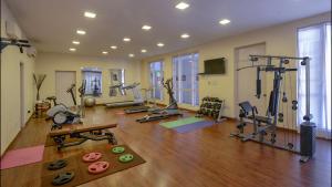 a gym with several treadmills and machines in a room at Hotel Clarks Varanasi Limited in Varanasi