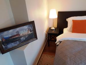 a bedroom with a picture of a train on the wall at Kotedžas prie jūros in Palanga