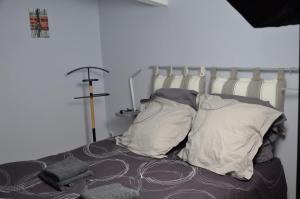 a bedroom with a bed with pillows on it at Mas du Puech Cymbale in Assas