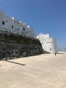 a person walking in front of a castle at CASA FLAMI' in Ostuni