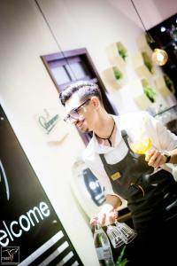 a man in a kitchen preparing food in a kitchen at Nest in Drobeta-Turnu Severin