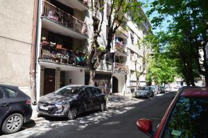 a street with cars parked in front of a building at Apartment ON TOP 23 in Belgrade