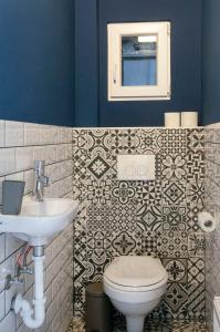 a bathroom with a toilet and a sink at Stylish downtown apartment in Budapest