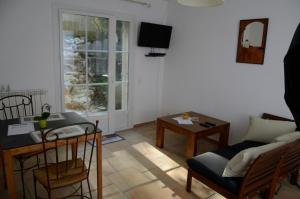 a living room with a couch and a table at Mas du Puech Clapas in Assas