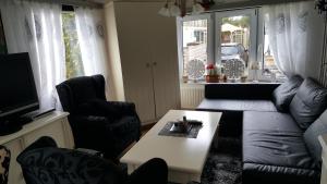 a living room with a couch and a coffee table at Ferienhhaus-Mobilheim freies WLAN in Sirjansland