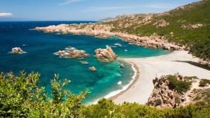 a view of a beach with rocks in the water at Recidence il gabbiano in Valledoria