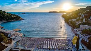 an aerial view of a beach with umbrellas at Villa Arancia in Dubrovnik