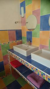 a bathroom with a sink and a mirror at Chambre d'Hôtes Les Bruyères in Cadouin +28 photos
