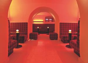a red room with red chairs and a red carpet at Hotel Bulwar in Toruń