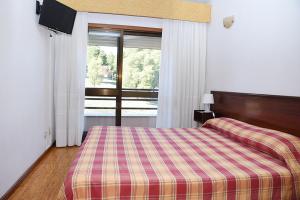 Postel nebo postele na pokoji v ubytování Hotel Val Flores