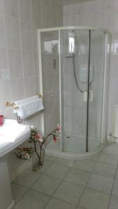a white bathroom with a shower and a sink at Disblair House in Newmacher