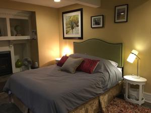 a bedroom with a bed with two pillows on it at Robert Porter House Inn in Victoria