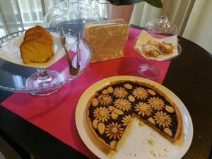 a table with a cake and a plate of food at Il Fiore in una Stanza in Itri