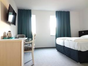 מיטה או מיטות בחדר ב-Hotel SAX Gračanica