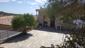 a patio of a house with a table and trees at casa di Chiara in San Teodoro +17 photos