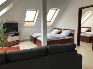 A bed or beds in a room at Kálvária Apartman