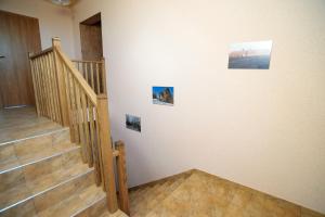a staircase with three pictures on the wall at Wieża Kruszewo in Kruszewo