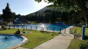 een groot zwembad met een berg op de achtergrond bij Apartamentos La Eliza in Lanzahita