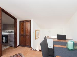 a living room with a table and a kitchen at Navona Penthouse in Rome