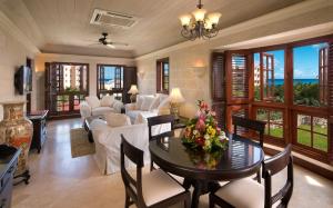 a living room filled with furniture and a large window at The Crane Resort in Saint Philip