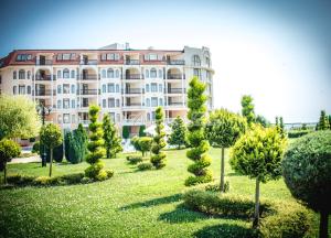 a large building with trees in front of it at Apart Hotel Apolonia Palace in Sinemorets