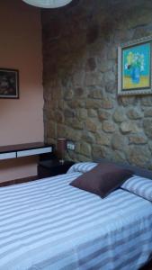 מיטה או מיטות בחדר ב-Alojamiento Rural Goierri
