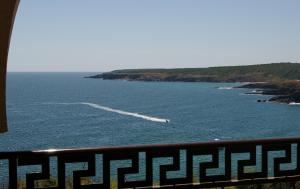 a boat in a large body of water at Apart Hotel Apolonia Palace in Sinemorets