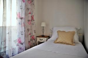a bedroom with a bed with a pillow and a window at Apartman Lucita in Split