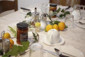 a table with a white table cloth with lemons on it at Apartments and Rooms Deskovic in Mošćenička Draga