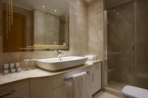 a bathroom with a sink and a shower at dovsOtel in Manisa