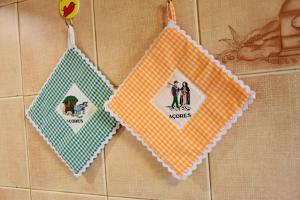 two napkins hanging on a wall with a couple at LAGOON'S HOUSE in Sete Cidades +34 photos