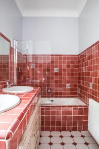 un bagno piastrellato rosso con due lavandini e una vasca di Stunning seaview villa. Villefranche Sur Mer a Villefranche-sur-Mer Altre 44 foto