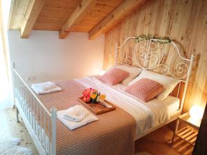 a bedroom with a white bed with a wooden ceiling at Apartment Cernesa in Ražanac