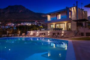 a villa with a swimming pool at night at Orama 4 bedroom Villa with private pool in Hersonissos