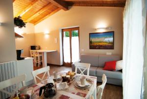a living room with a couch and a table at Agriturismo La Zangola in Tremosine Sul Garda +39 photos