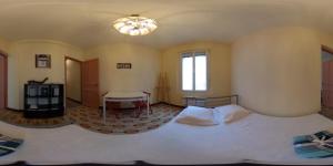 a bedroom with a large white bed and a table at Chez'Artistes in Argelès-sur-Mer