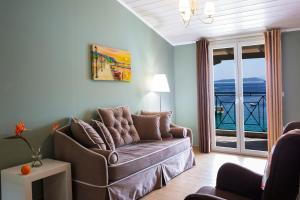 a living room with a couch and a view of the ocean at Captain Nick Aparthotel in Mikros Gialos