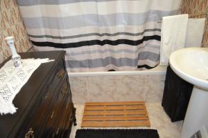 a bathroom with a toilet and a bath tub at Casa Vintage Guest House in Peniche