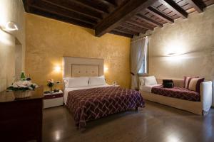 a hotel room with two beds and a couch at Relais Maddalena in Rome