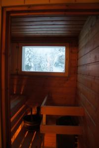 a small cabin with a window and a bench at Heidin Mummola Farm in Pello