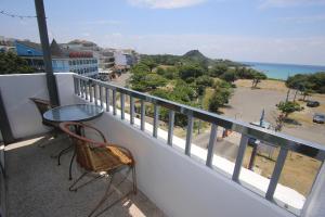 a balcony with a table and chairs and the ocean at Kenting Waterfront Hotel in Kenting