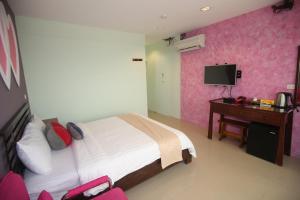 Postel nebo postele na pokoji v ubytování Kenting Waterfront Hotel