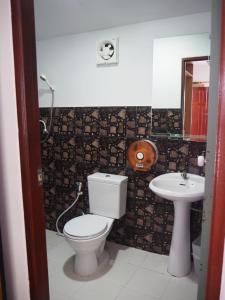 a bathroom with a toilet and a sink at Bluesky Beach Bungalows in Ko Lanta