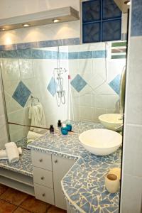 a bathroom with two sinks and a shower at Villa les Alizés in Les Trois-Îlets