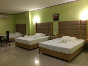 En eller flere senge i et værelse på Asia Novo Boutique Hotel - Oroquieta