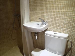 a bathroom with a white toilet and a sink at No1 CasaTosca Javea, Pequeña Habitación con baño en el Centro del Casco Antiguo in Jávea